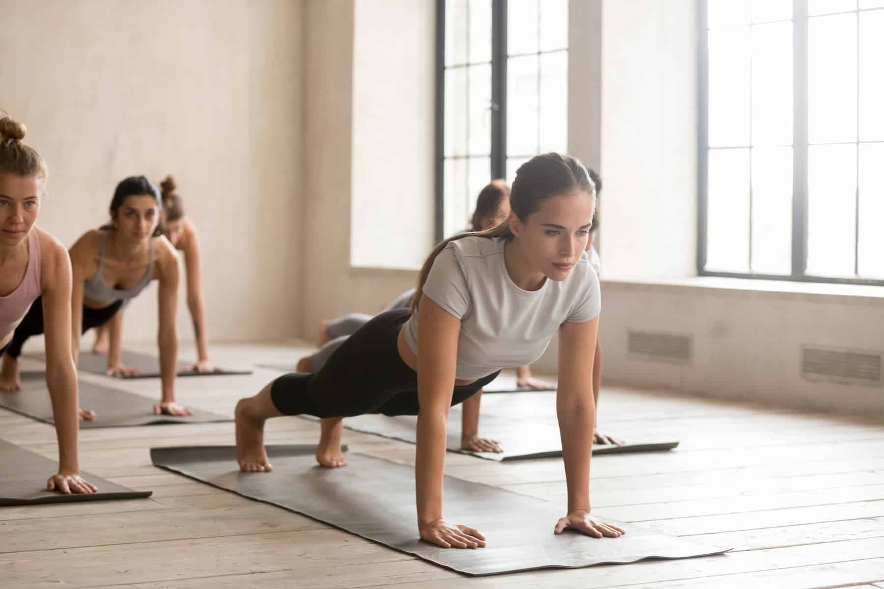 Group of young women practicing yoga to release stress and anxiety.