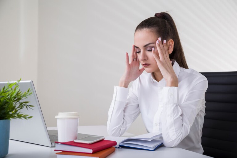 Young woman feeling overwhelmed with too much to do needs to break big goals into smaller steps to make it more manageable.