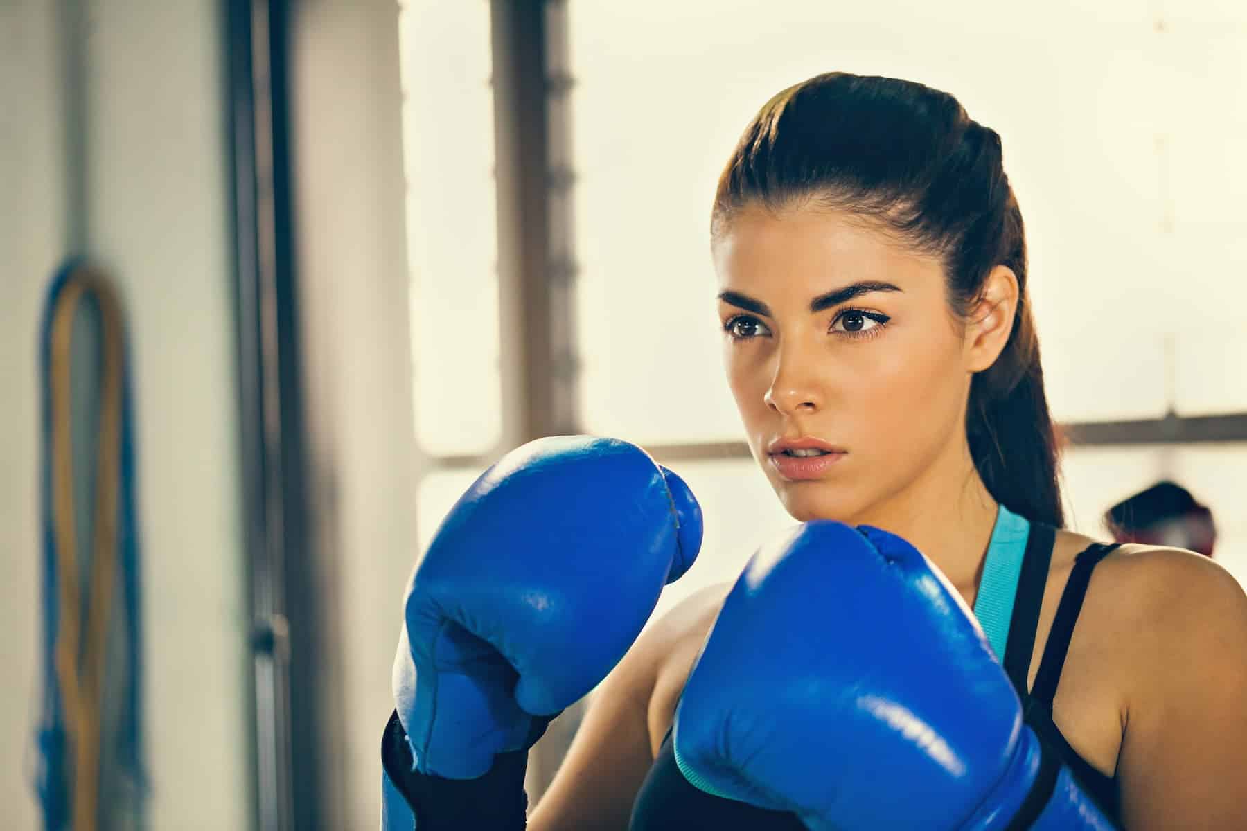 A female boxer is in training, ready to confront the concept of her mediocre mentality.