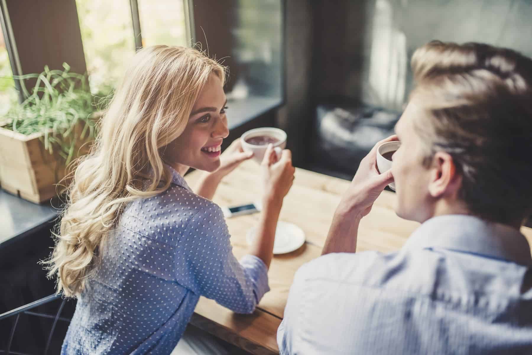 A woman embraces her vulnerability, being her authentic self as she talks with a man at a table.