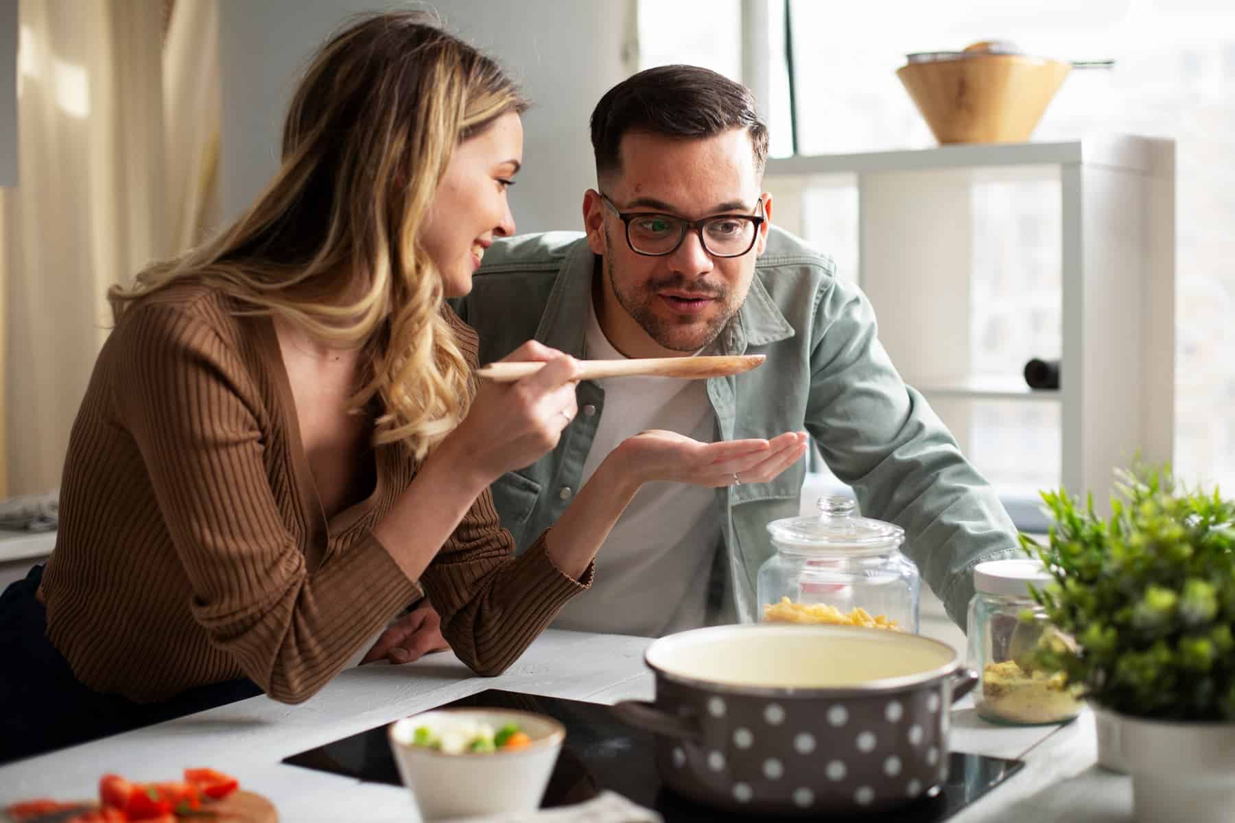 A highly sensitive woman puts extra effort into preparing a meal, hoping it will bring joy to her partner and strengthen their bond.