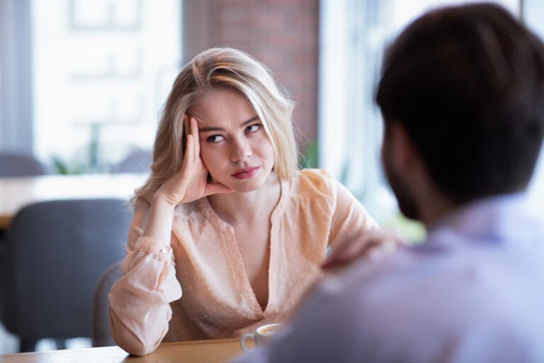 A young woman is sitting in a café with her significant other, wondering why she is settling for mediocrity in her relationship.