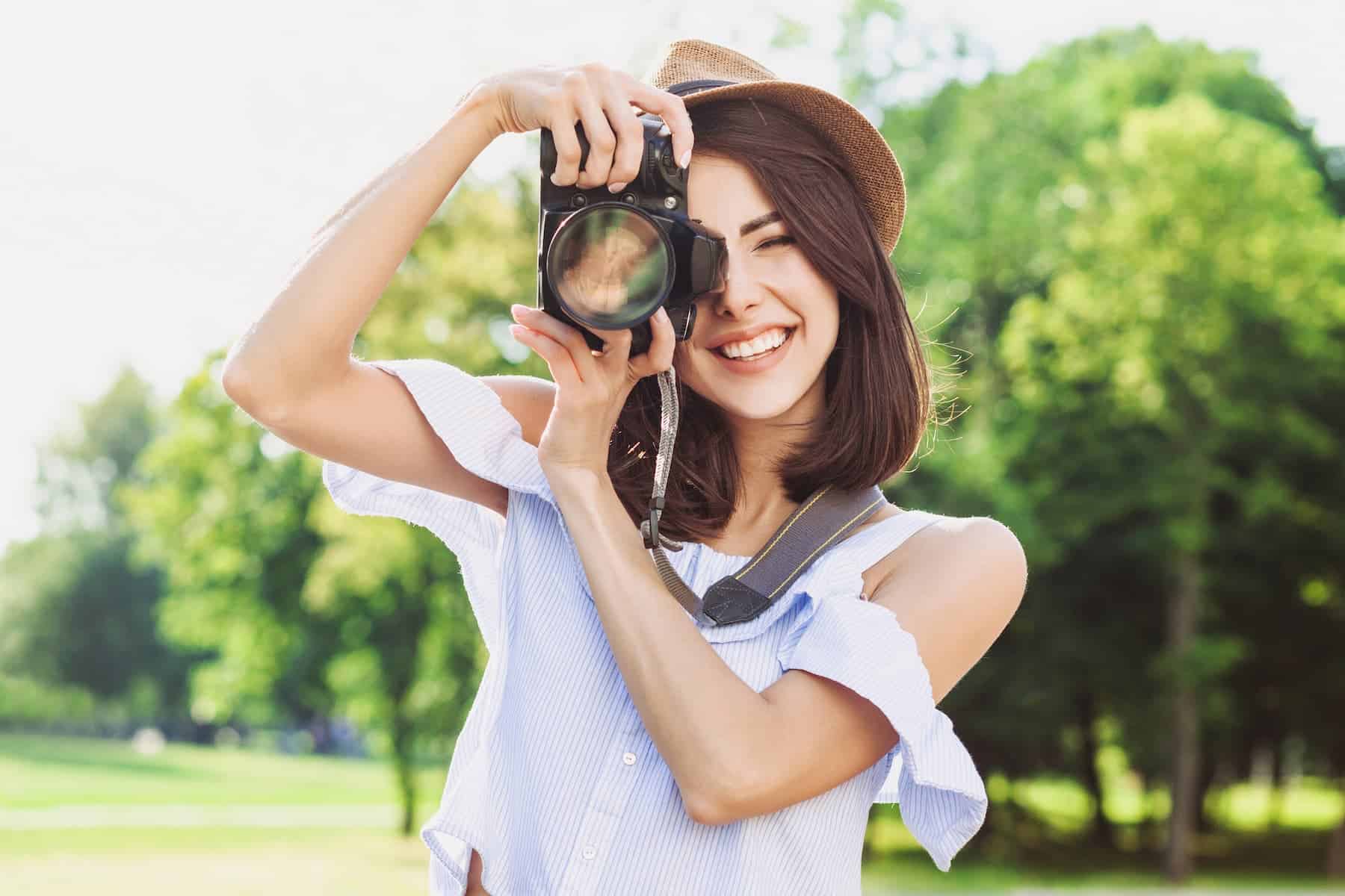 Woman enjoying taking photos with her camera as her hobby.