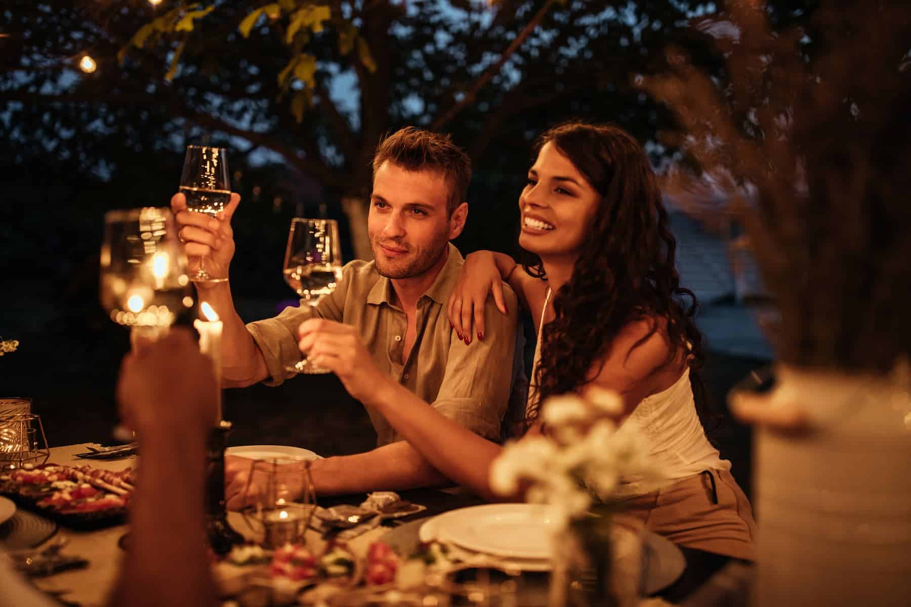 Highly sensitive people enjoying an outdoor dinner and wine, debunking the myth that only women are highly sensitive.