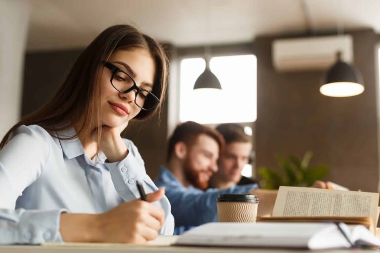 A smart girl studying in a library, writing an essay and sipping coffee, highlighting the importance of continuous learning and personal growth.