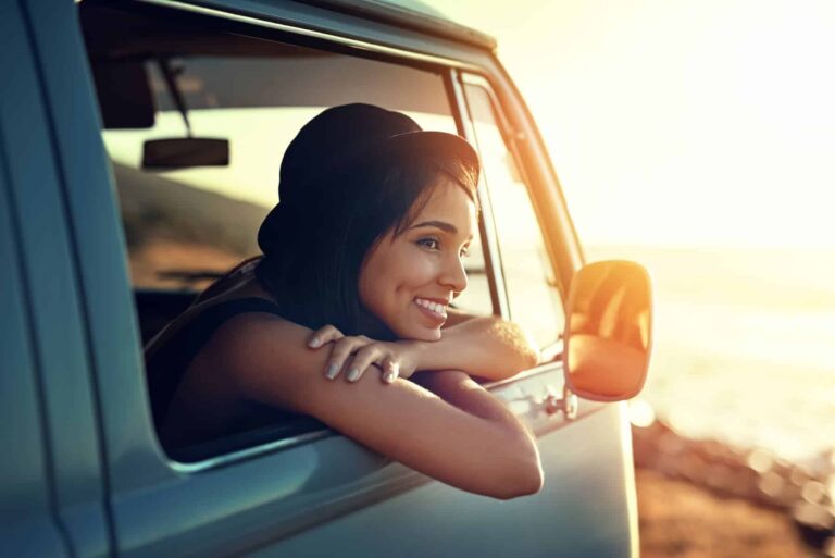 Shot of a young woman who knows her self-worth is enjoying a relaxing roadtrip sitting in a van.