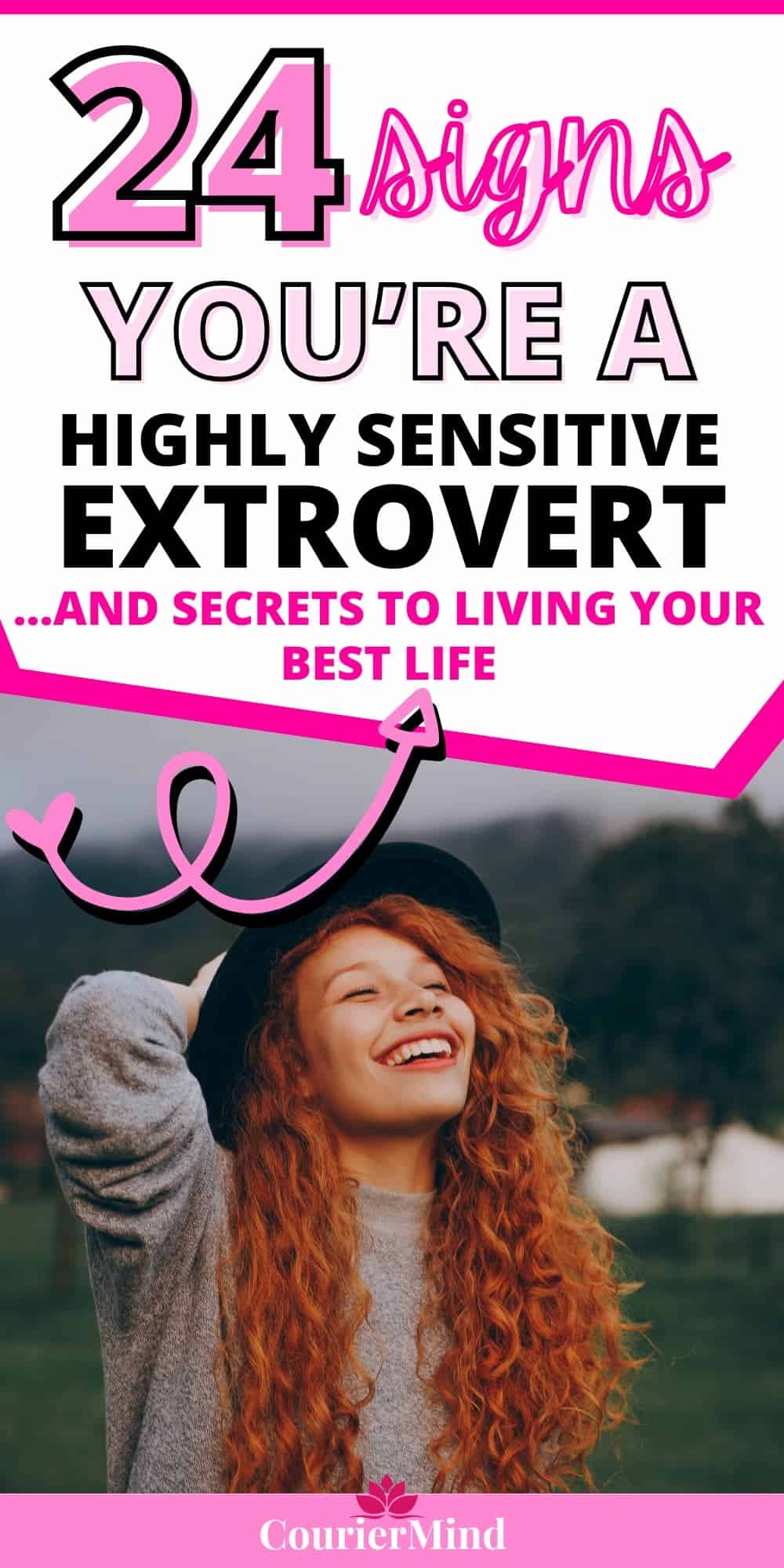 A woman with red hair and a black hat, smiling and embracing her life as a highly sensitive extrovert, enjoying every moment.