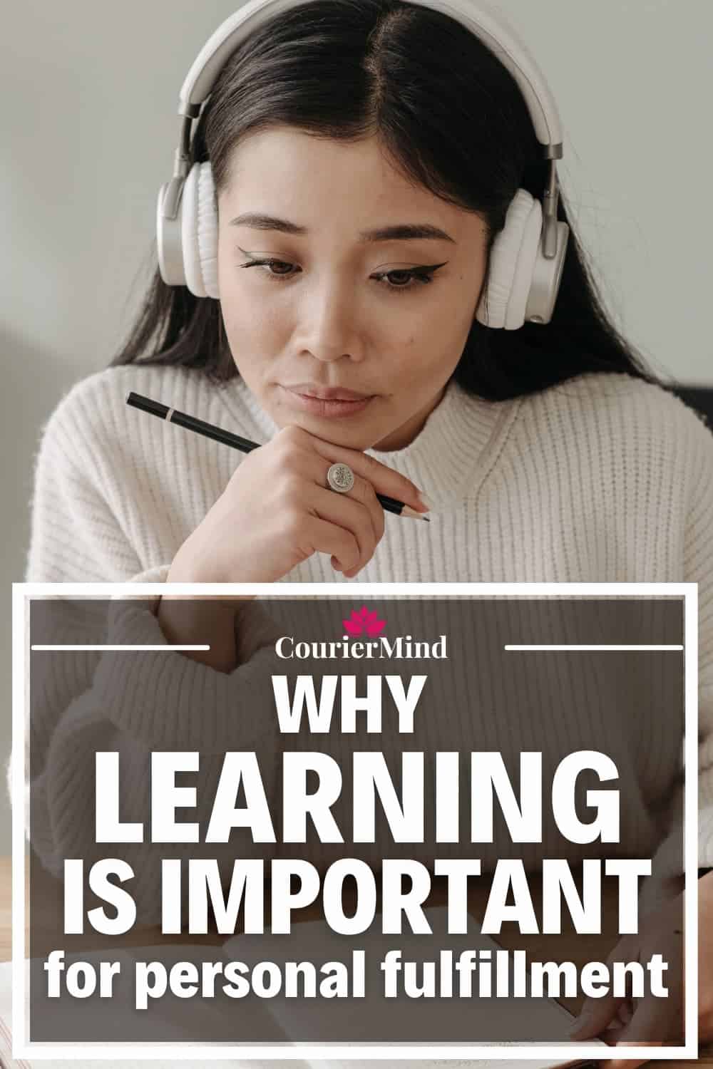 A young woman in a white sweater and headphones studies for an exam, showcasing the importance of continuous learning for personal fulfillment.