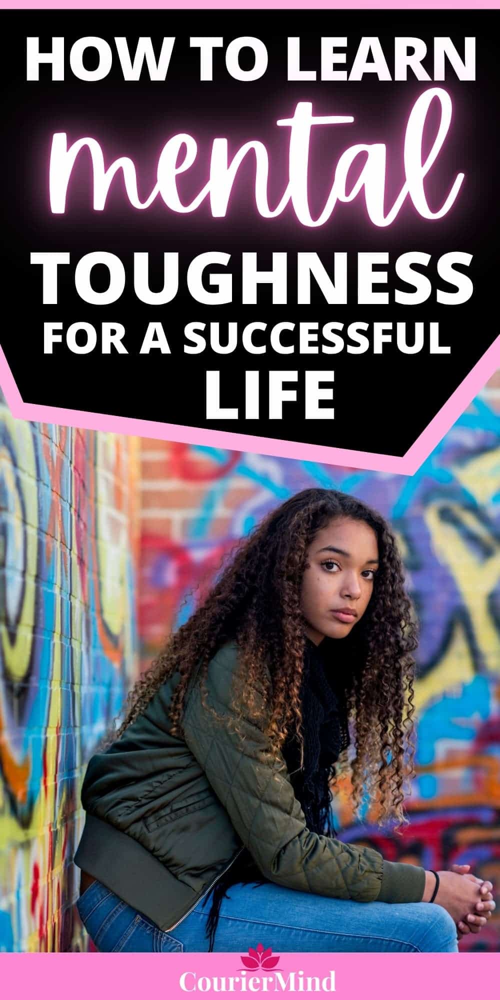 Vulnerable woman in a green bomber jacket sitting outdoors against a graffiti wall, illustrating the importance of building mental toughness in a challenging world.