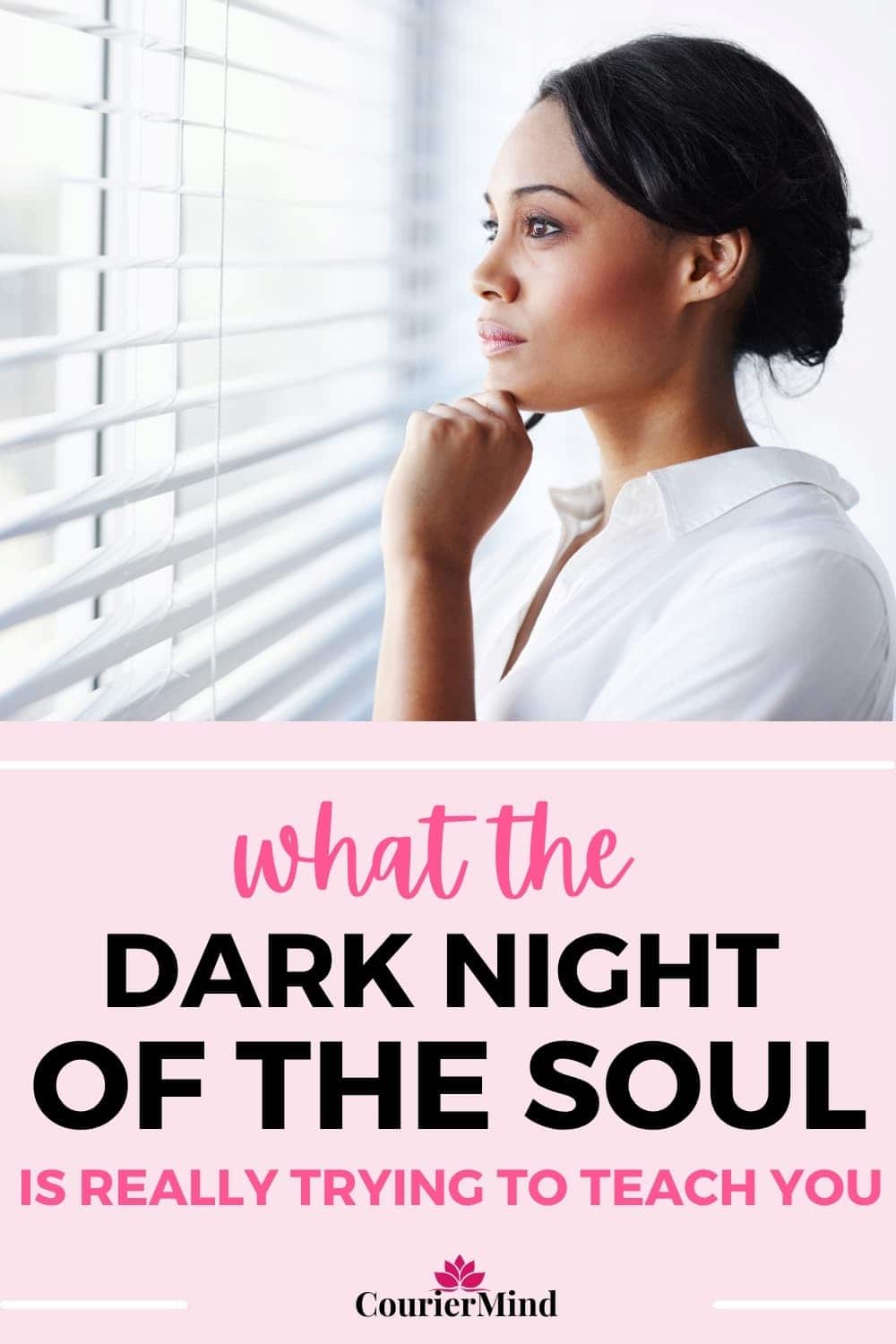 A woman in a white shirt looks out the window, contemplating what the dark night of the soul is trying to teach her.