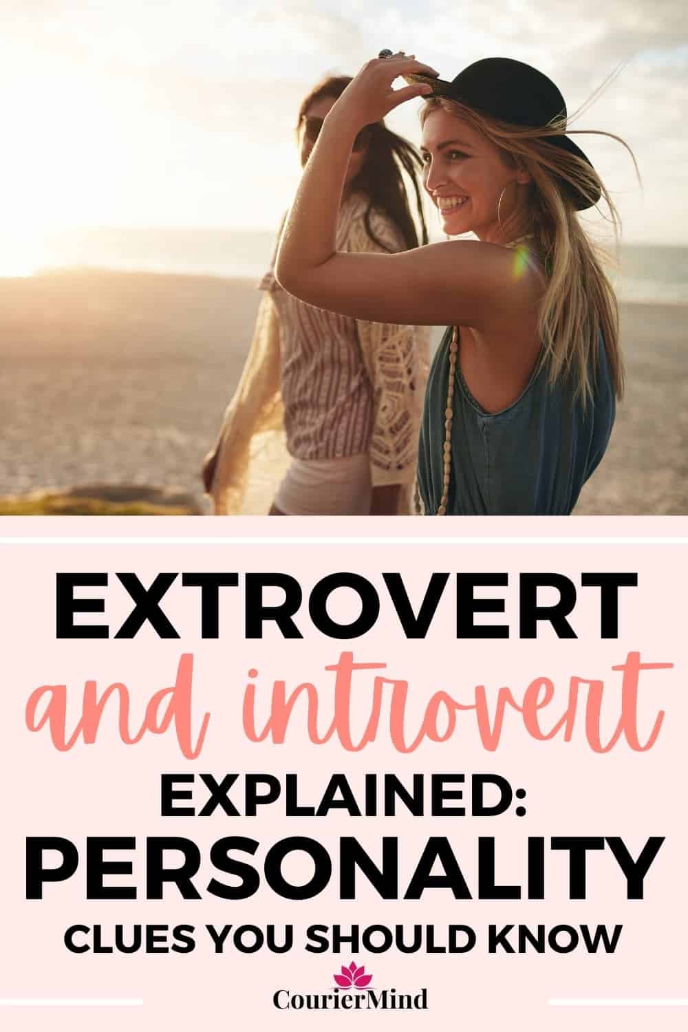 Two people walk along a beach at sunset, one adjusting a hat and smiling, illustrating shared moments between extrovert and introvert friends.