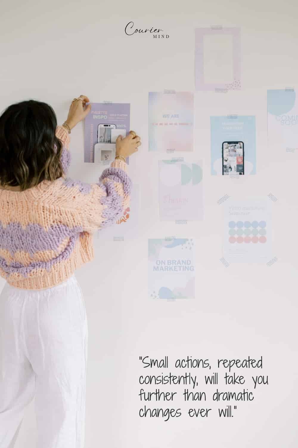 Woman pinning flyers to a wall while working toward goals beyond a mediocre mindset.