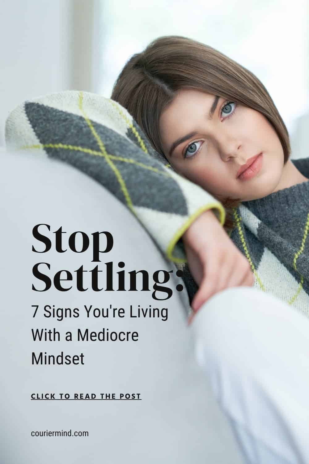 A woman in a grey argyle sweater sits on a sofa looking bored, illustrating the disengagement of a mediocre mindset.