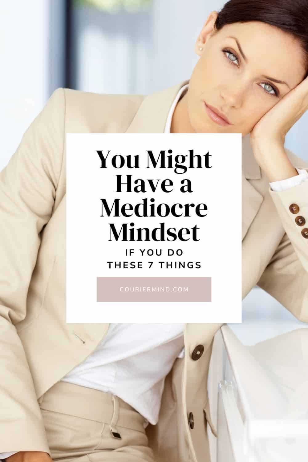 A woman in a tan suit rests her head on her hand with a bored expression, reflecting the complacency of a mediocre mindset.