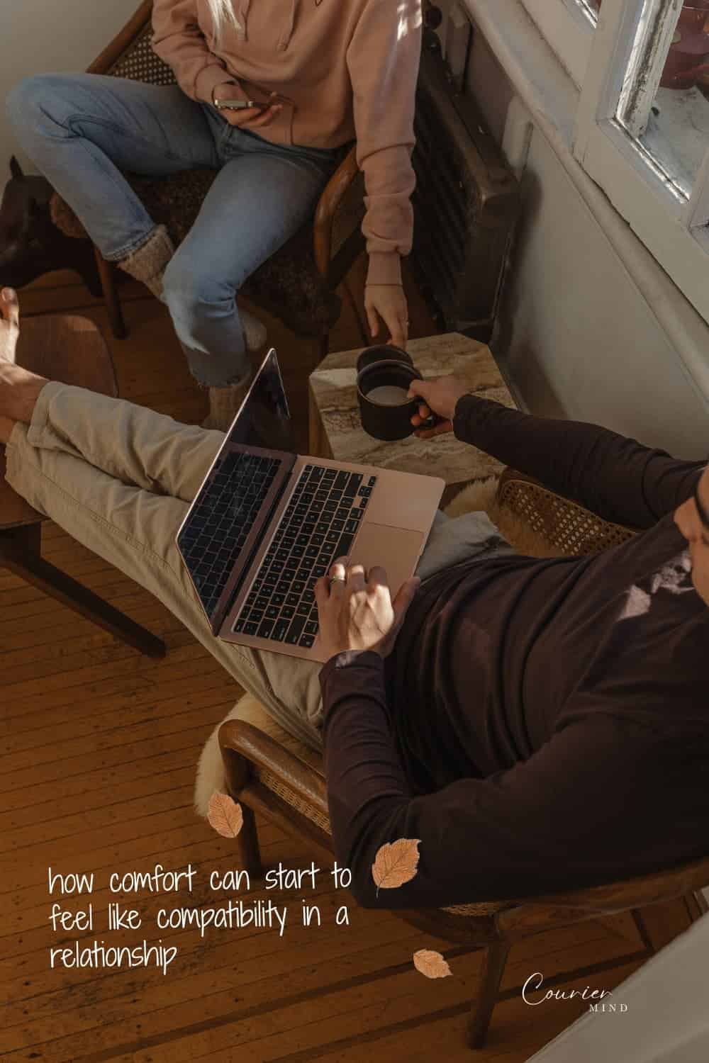 Couple sitting together with a laptop and coffee mugs, reflecting quiet distance in mediocre relationships.