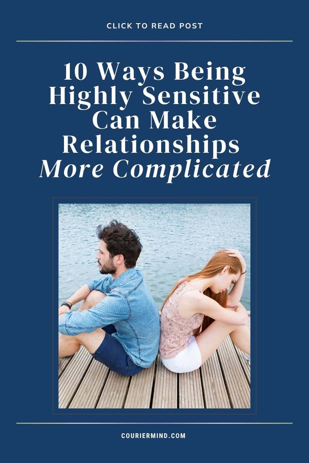 A couple sits back-to-back on a dock by a lake, with one person looking away while the other covers her face with her hands.