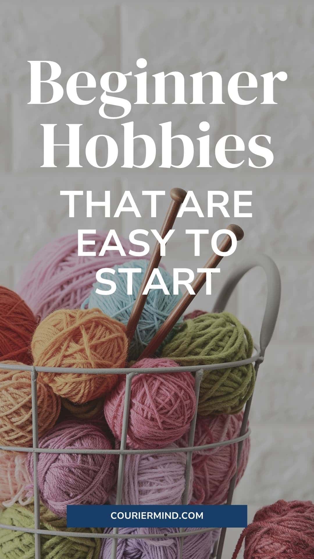 Colorful balls of yarn stacked in a metal wire basket, with two wooden knitting needles.