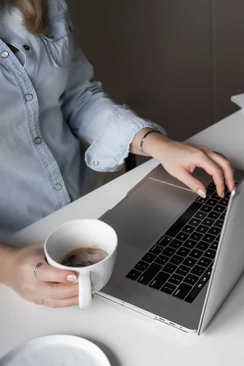 Woman working at desk with a laptop.