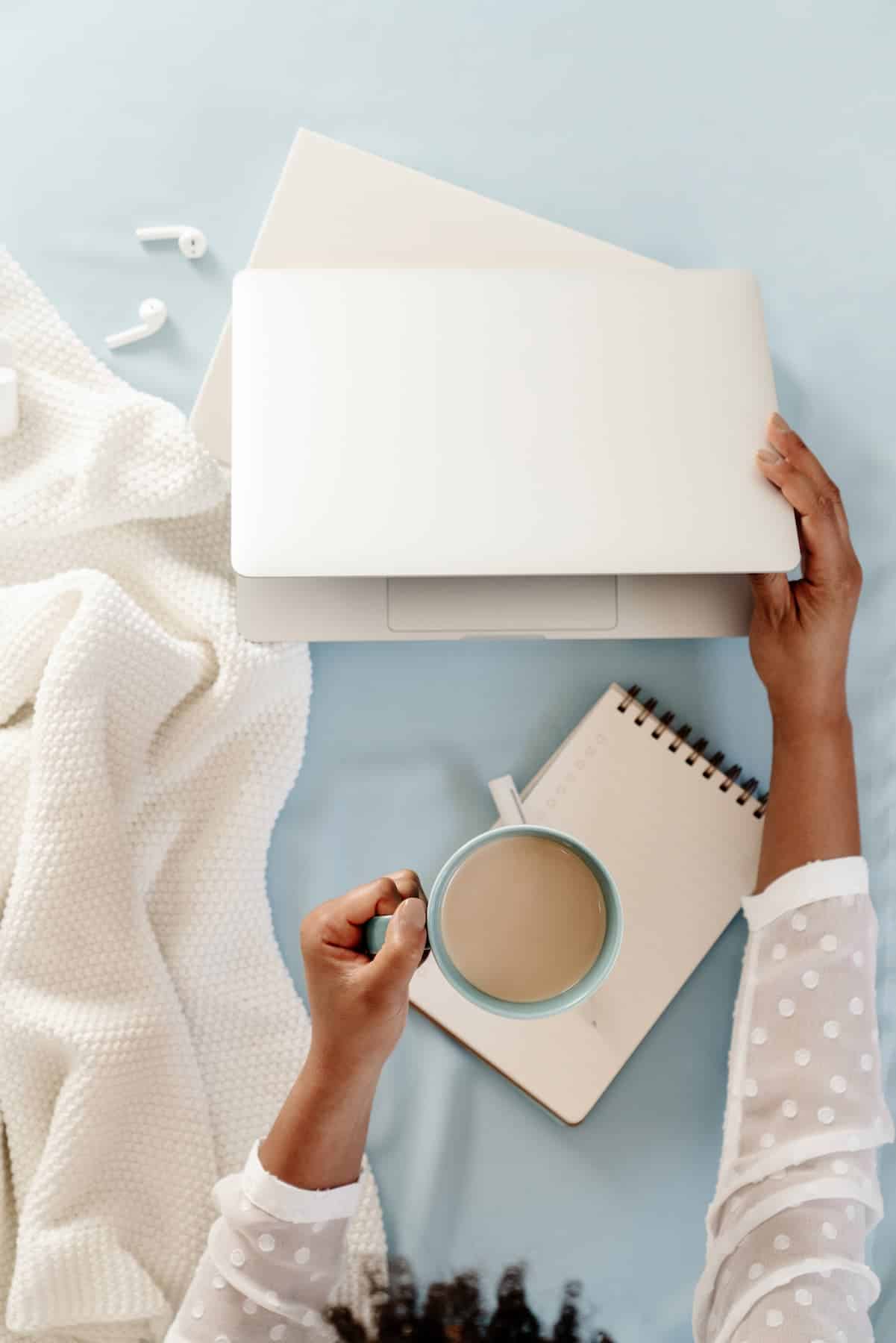 Woman working on her laptop from bed.